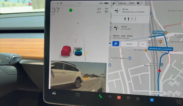 An animated depiction on the Tesla screen illustrates lane changes, highlighting your position and surrounding vehicles to enhance visual assistance for safer lane transitions.