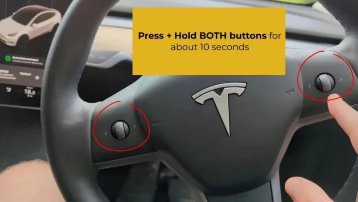 Instructions for restarting the Tesla touchscreen using scroll buttons.