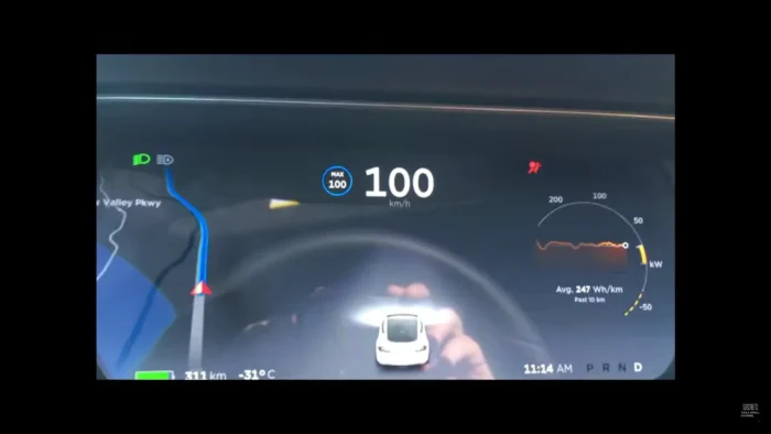 Airbag light on the dashboard, indicating a potential screen reboot issue in a Tesla