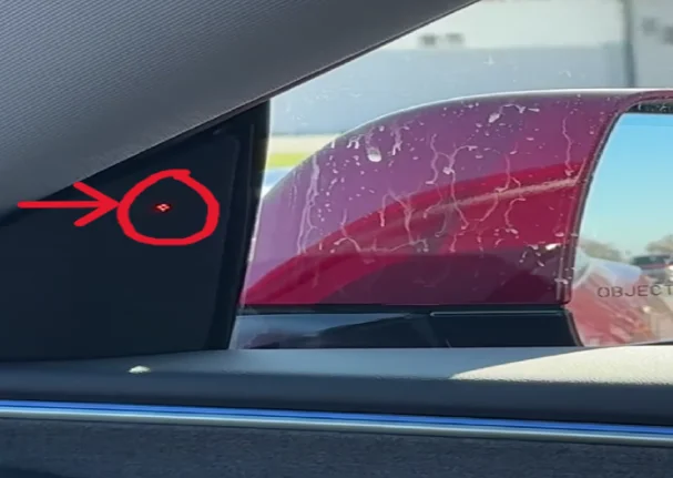 Tesla's blind spot indicator in the upper speaker grille illuminates red when a vehicle is detected in your blind area, providing visual warnings.