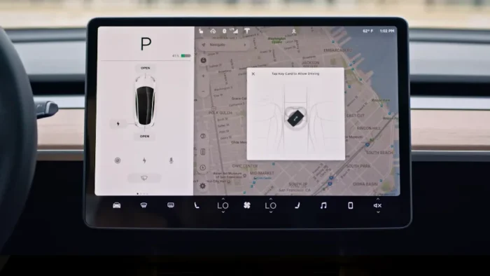 Tesla touchscreen displaying a prompt to tap the key card to drive