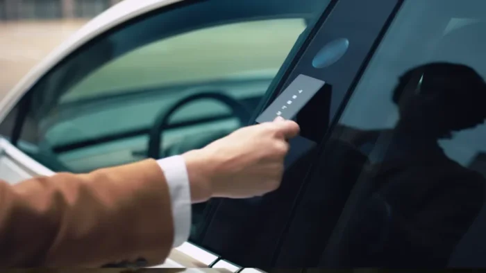 Tesla key card being tapped on the driver's side door pillar