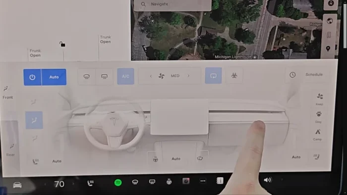 Tesla touchscreen displaying climate control options for adjusting fan speed and temperature.