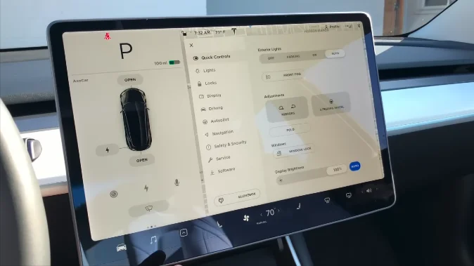 Tesla touchscreen with touch, scroll, and voice command features highlighted.