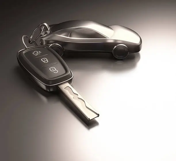 Key car and key ring over the metallic table. Clipping path included.
