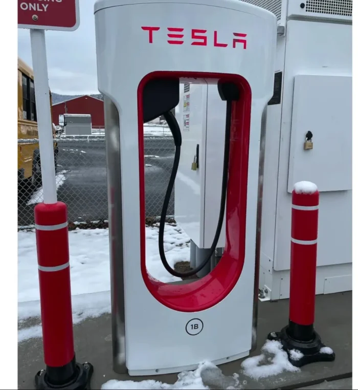 Tesla Supercharger station showing fast charging capabilities with a car being charged.