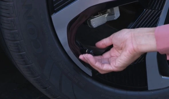 woman checking tire